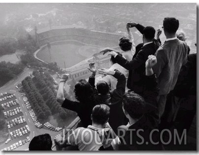 University of Pittsburgh Students Cheering Wildly from Atop Cathedral of Learning on School