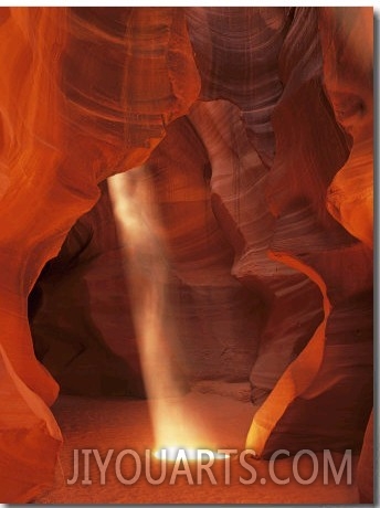 Sunbeam Illuminates Sandy Floor and Sandstone Walls of a Slot Canyon