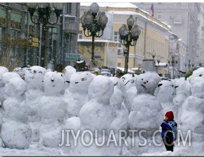 A Child Plays Among the Snowmen Made at the Arbat