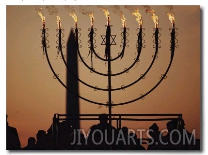 Silhouetted Worshippers Stand Before a Large Menorah Near the Washington Monument