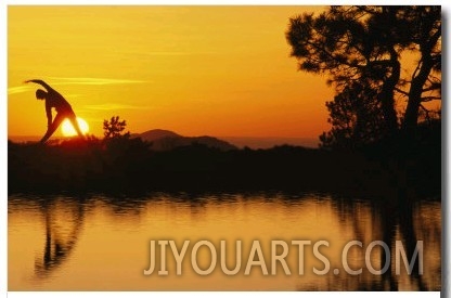 Woman Stretching during Yoga with Setting Sun