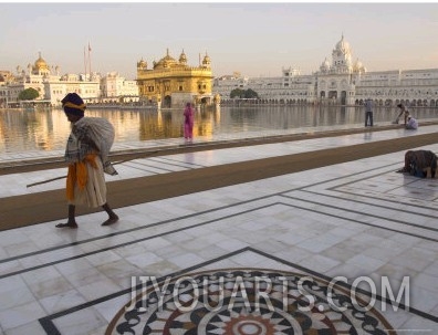 Elderly Sikh Pilgrim with Bundle and Stick Walking Around Holy Pool, Amritsar, India