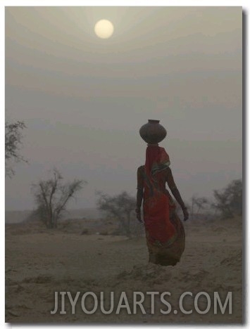 Woman Carrying Water Jar in Sand Storm, Thar Desert, Rajasthan, India