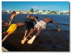 Young Boys Dive Off Marina at Bay of Belize with City in Background, Belize City, Belize