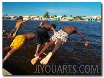 Young Boys Dive Off Marina at Bay of Belize with City in Background, Belize City, Belize