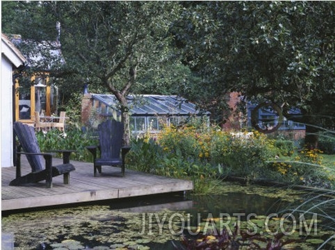 View across Lily Pool to Deck with Adirondack Chairs, in the Background Is the Main Greenhouse