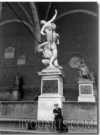 Man Sitting Beneath Statue