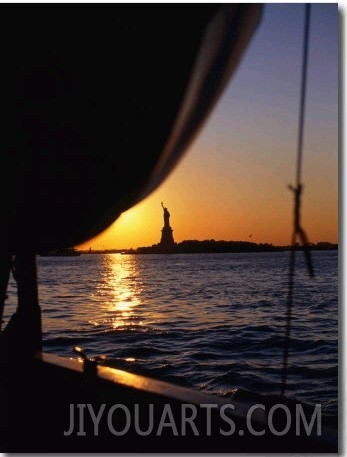 Statue of Liberty at Sunset from Staten Island Ferry, New York City, New York, USA