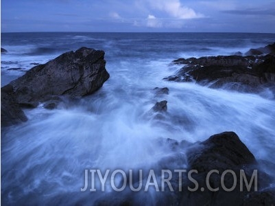 High Tide Brings in Waves on a Rocky Shoreline