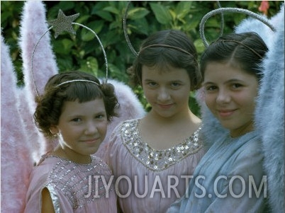 Smiling Young Girls Wear Angel Costumes for an Easter Procession