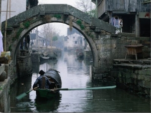 A Bamboo Boat Makes Its Way Through Shaoxing Water Town, Shaoxing, Zhejiang, China